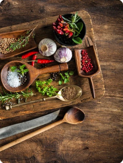 Fresh herbs, garlic and spices on a wooden board