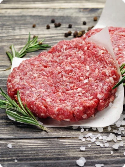 Uncooked patties arranged with herbs